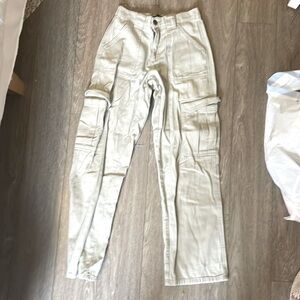 Soft light green jeans, with pockets in the front and back, zip up.